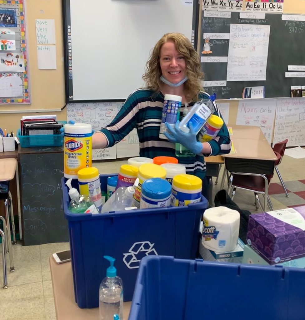 Civilians associate artist Emily Ackerman with the some of the leftover cleaning supplies she collected from a closed school to donate to essential workers. Photo courtesy of Emily Ackerman.